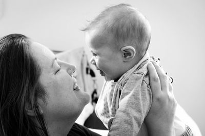 Close-up of mother and daughter embracing at home