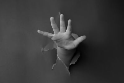 Close-up of woman hand over black background