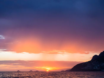 Scenic view of sea against romantic sky at sunset