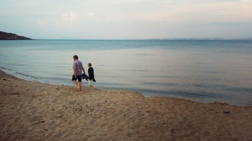 Rear view of people on beach