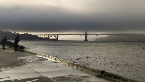 Bridge over sea against sky