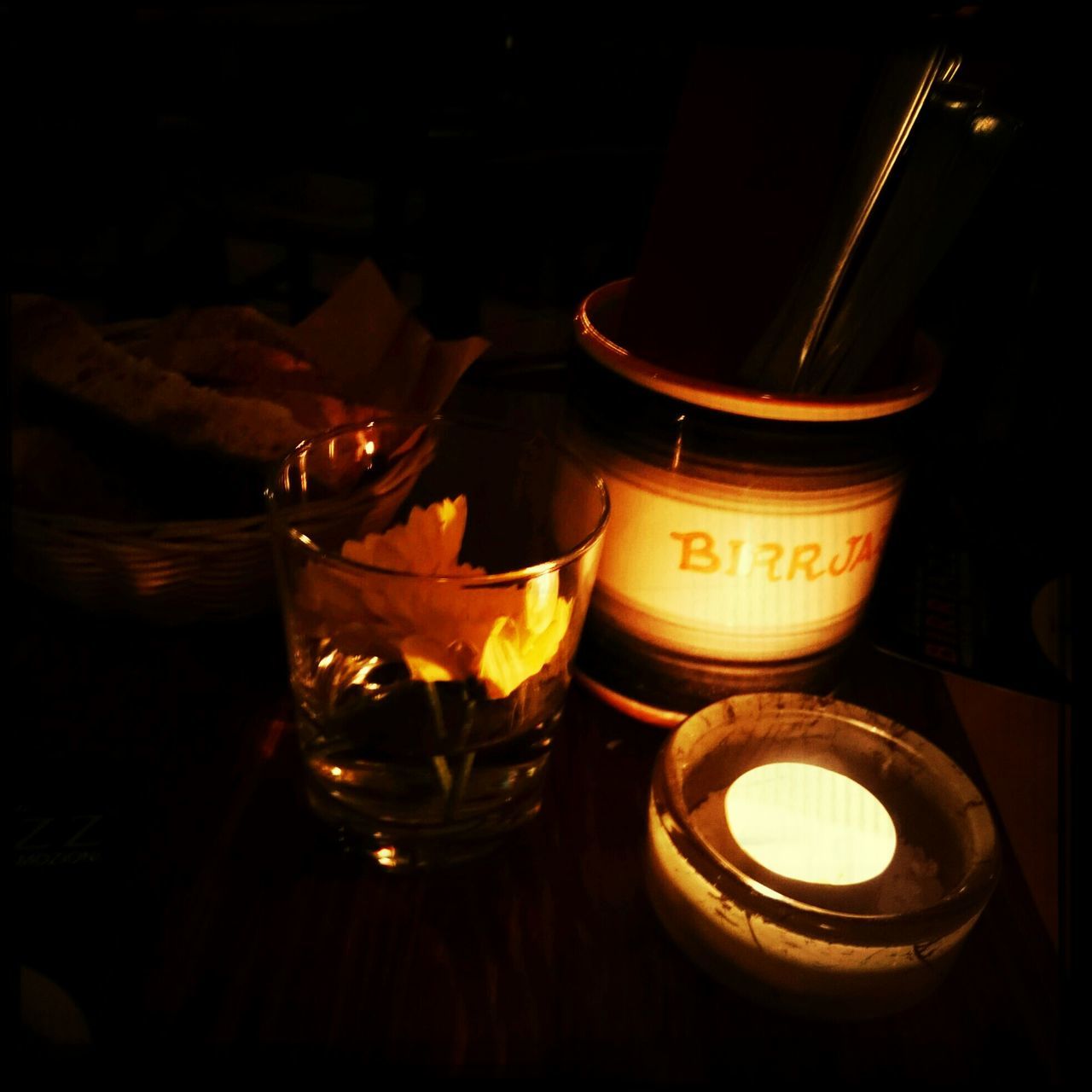 indoors, still life, table, drink, close-up, candle, illuminated, food and drink, burning, black background, glass - material, refreshment, no people, drinking glass, night, alcohol, flame, high angle view, bottle, lit