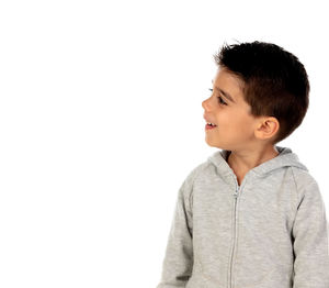 Boy looking away against white background