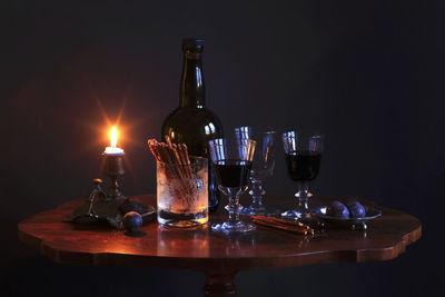 Glass of wine bottles on table