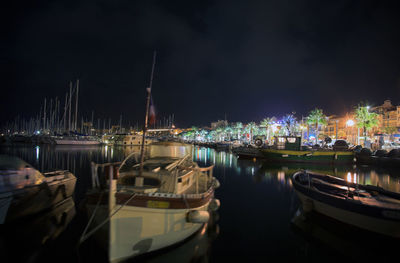 Boats in harbor at night