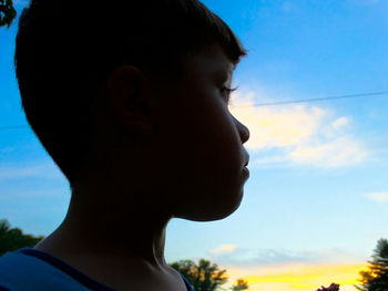 Close-up of girl against sky