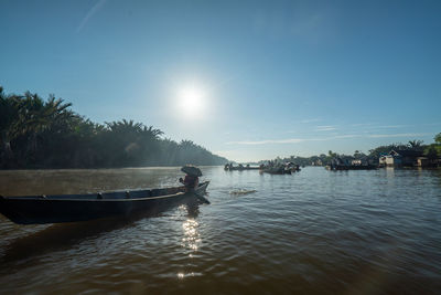 Man on boat against sky