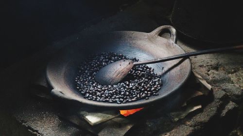 Close-up of coffee beans being roasted in container