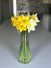 Close-up of yellow flowers in vase on table