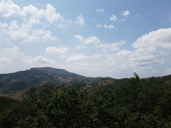 Scenic view of mountains against cloudy sky