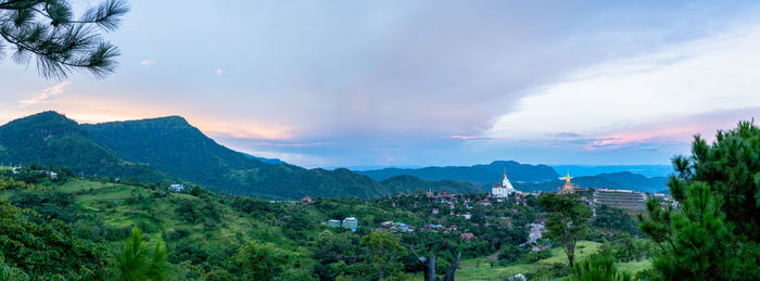 Panoramic view of townscape and mountains against sky