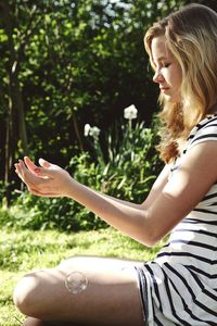 Woman sitting on a tree