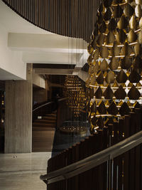 Illuminated lights hanging on staircase in building