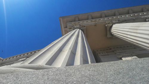 Walkway against clear blue sky