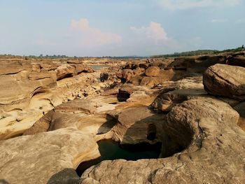 Rock formation on land against sky