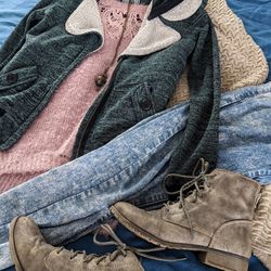 Close-up, high angle flatlay of rugged clothes and boots, ready to be worn on an adventure.