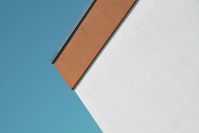 Low angle view of building against clear blue sky