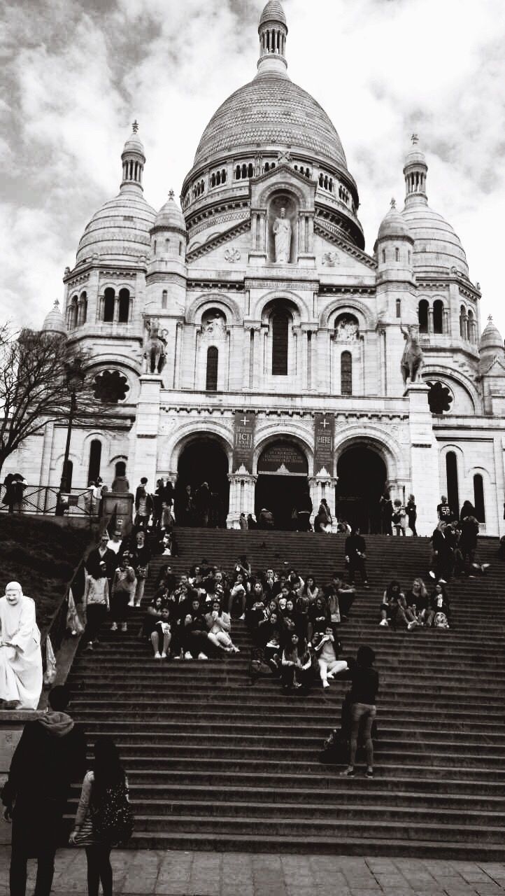 LOW ANGLE VIEW OF PEOPLE WALKING ON STEPS OF CATHEDRAL