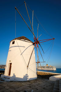 Traditional greek windmills on mykonos island at sunrise, cyclades, greece