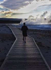 Rear view of man standing on beach