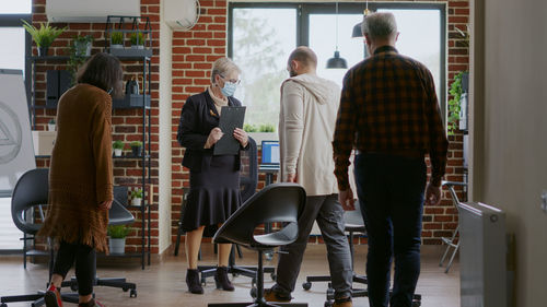 Rear view of business colleagues working at airport