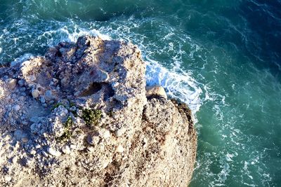 High angle view of rocks in sea