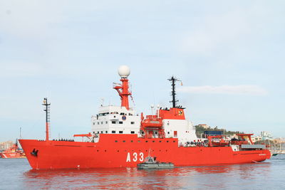 Ship moored on sea against sky