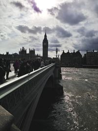Bridge over river with cityscape in background