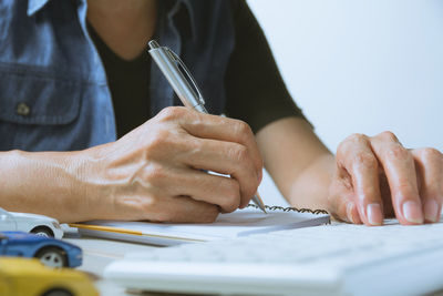 Midsection of man working on table