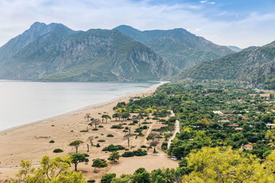 Scenic view of sea and mountains against sky