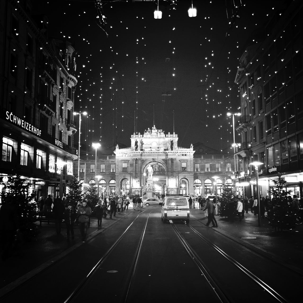 night, illuminated, building exterior, transportation, architecture, city, built structure, street, car, road, city street, street light, city life, road marking, land vehicle, mode of transport, the way forward, traffic, outdoors, incidental people