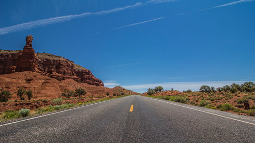 Road amidst rocks against sky