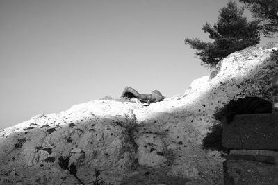 Low angle view of rocks against clear sky