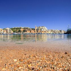 View of cityscape against clear blue sky
