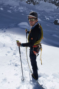 Full length of man standing on snowcapped mountain