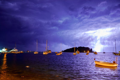 Sailboats in sea against sky