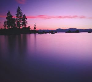 Scenic view of lake against romantic sky at sunset