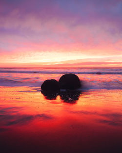 Scenic view of sea against romantic sky at sunset