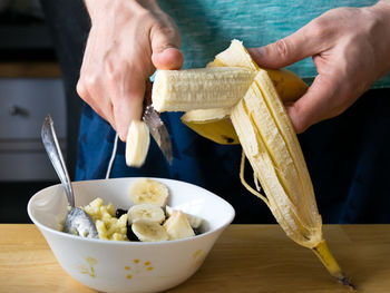 Midsection of man preparing food on table