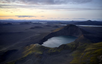 Calm lake in volcanic terrain in evening