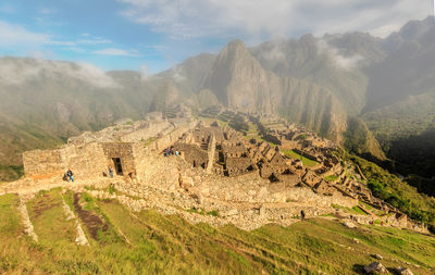 Scenic view of mountains against cloudy sky