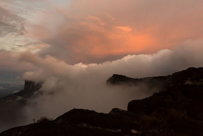 Low angle view of smoke emitting from volcanic mountain against sky