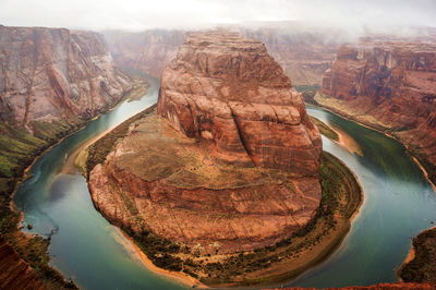 Aerial view of river flowing amidst canyon