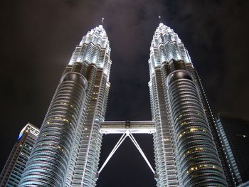 Low angle view of illuminated buildings against sky at night