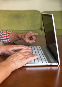 Midsection of man using mobile phone