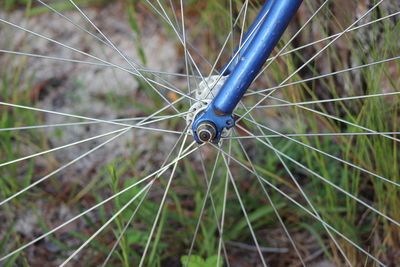 Close-up of bicycle wheel on field