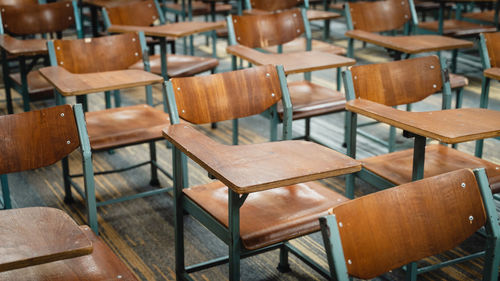 Empty chairs and tables in row