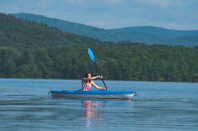 Man rowing boat in lake