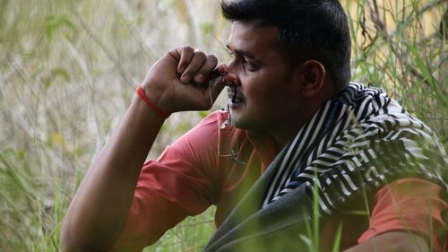 Side view of young man looking away