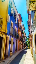 View of residential buildings against blue sky